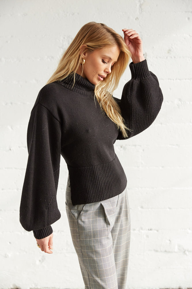 The side of this sweater shows off the long balloons sleeves.