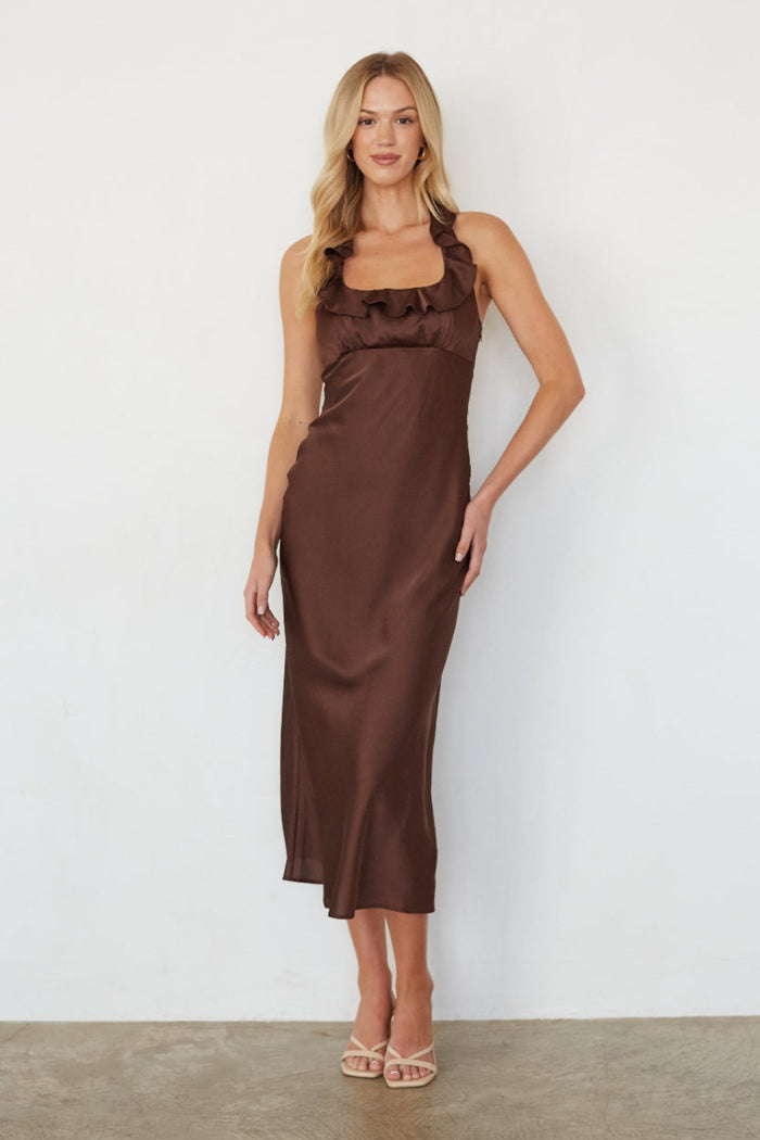 Woman wearing a brown satin dress against a white background