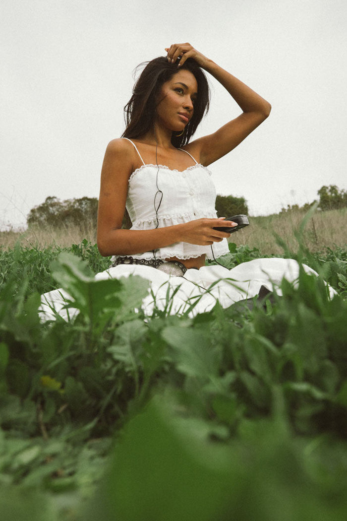 closeup-image | peplum white top | delicate and charming | close-up of the top’s fabric and ruffle details, adding a soft, peplum touch.