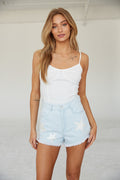 Front view of star denim shorts.