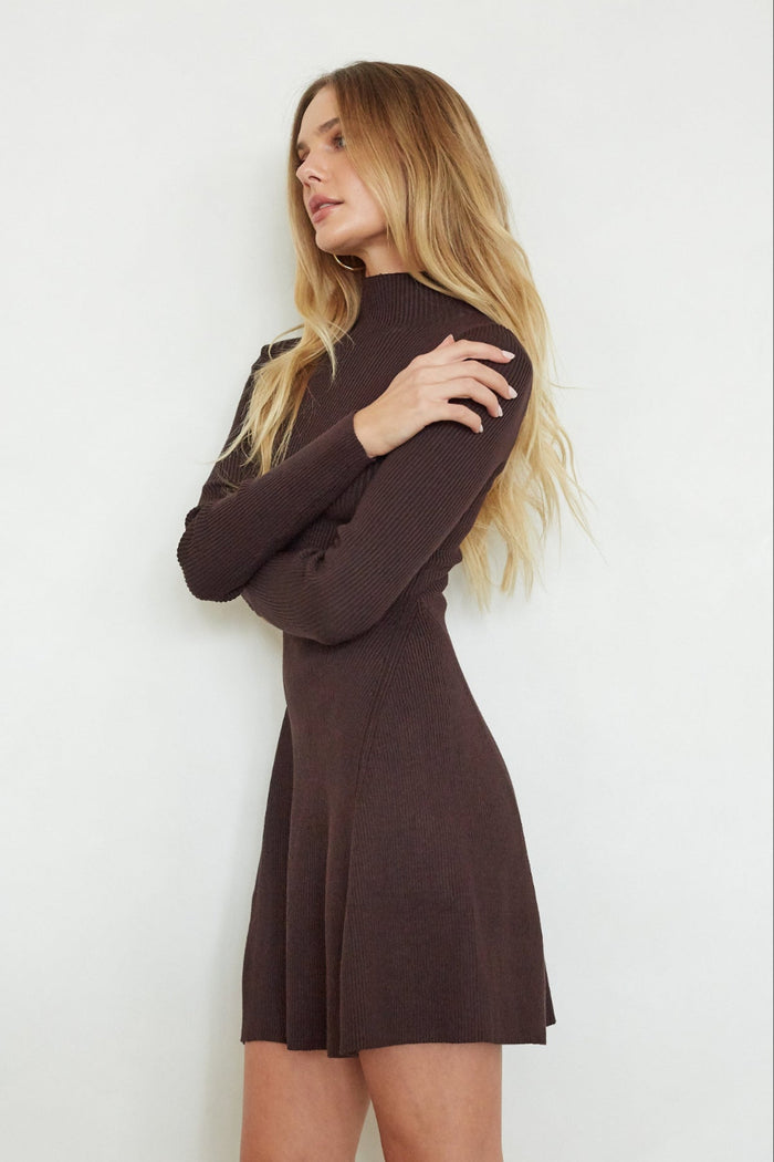 Woman wearing a brown dress against a white background