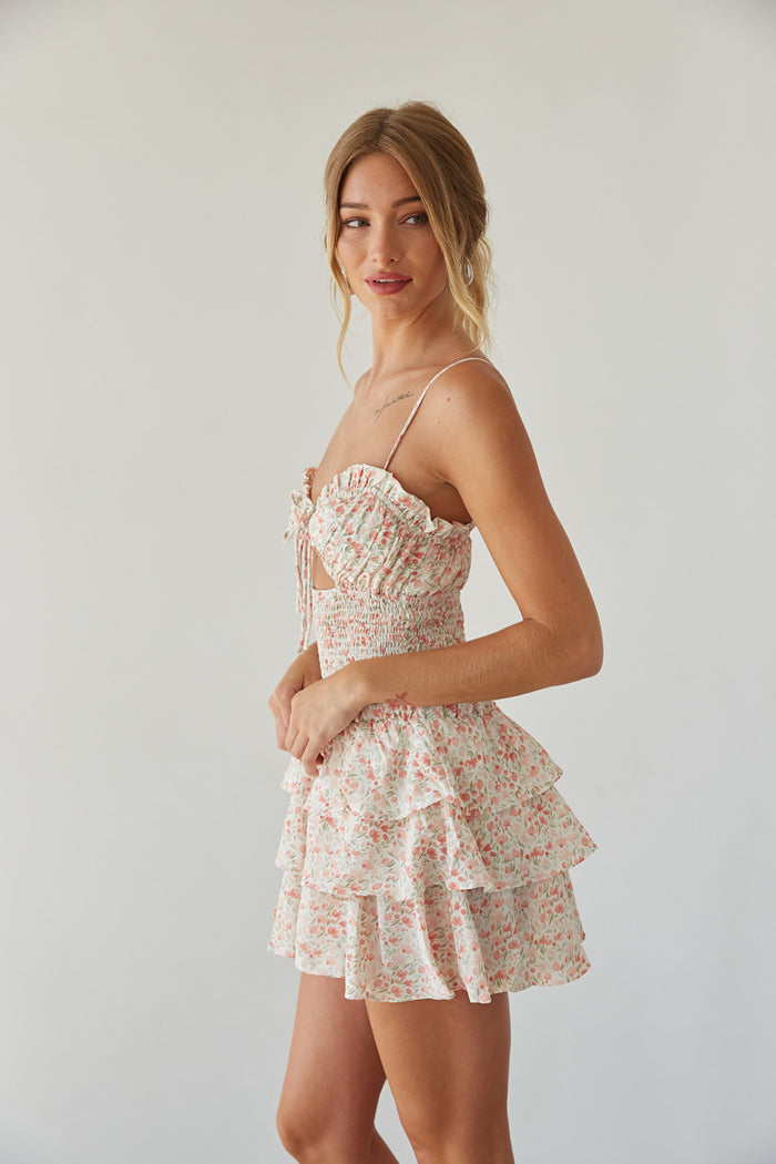 side view | pink floral romper with keyhole cutout, smocked waist, and tiered ruffle skirt