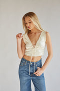 cream lace trimmed deep v satin crop top with front bow detailing | college crop top boutique