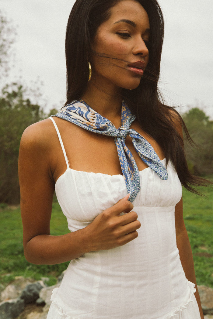 detail-image | white maxi dress | delicate | a close-up of the dress’s fabric texture, focusing on the pleated design and fine details