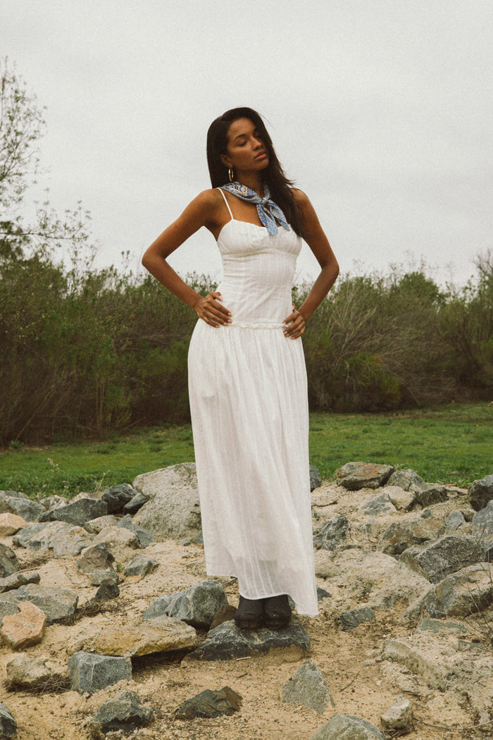 white maxi dress | elegant | the dress in a full front view, showcasing its long flowing skirt and simple neckline