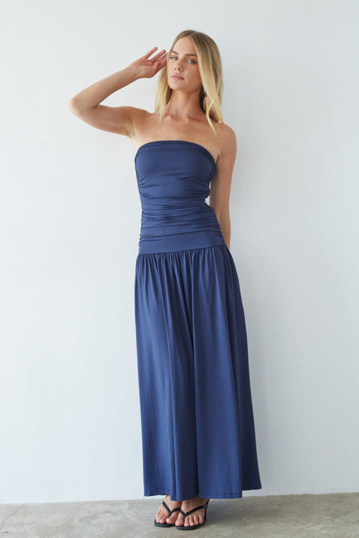 blue-image | Woman wearing a strapless blue dress against a white background