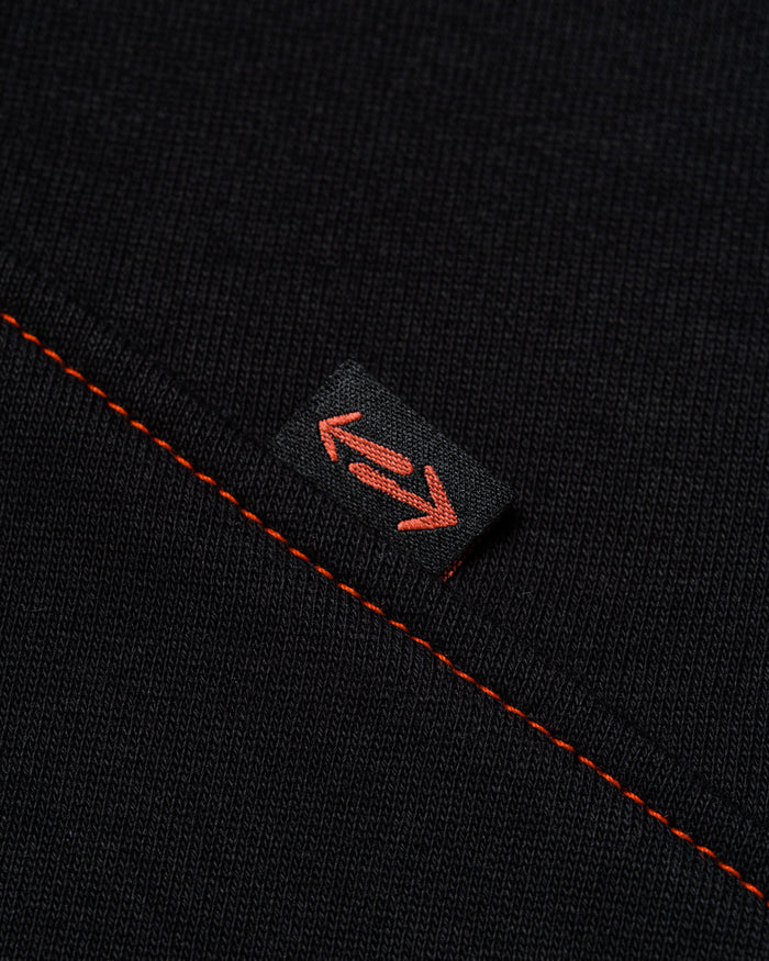 Outnback Recovery Cape in black, woven arrow tab detail