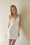 white-image | Woman wearing a white linen dress against a plain background