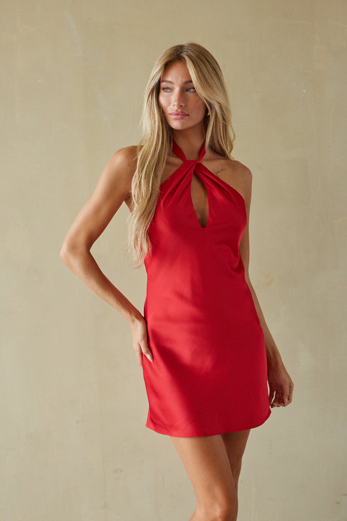 red-image | Woman wearing a red dress against a beige background