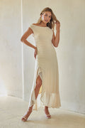 yellow-image | Woman wearing a white dress with a slit in a bright room