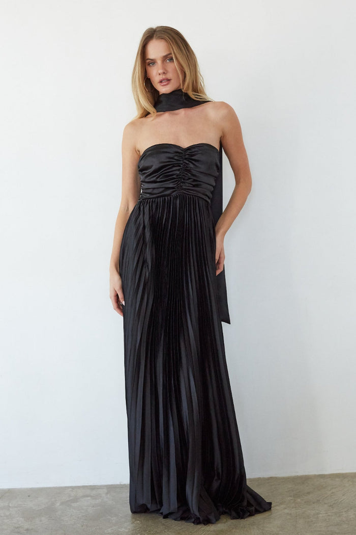 black-image | Woman wearing a black strapless gown against a white background