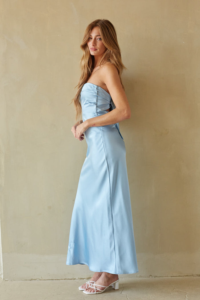 side-image | satin blue dress | smooth |  side profile revealing the form-fitting silhouette and elegant flow of the satin fabric.