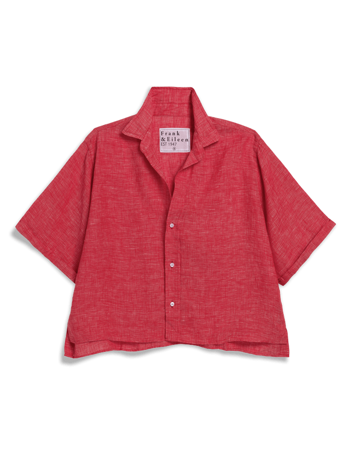 Red short-sleeve shirt with a brand label on a black background
