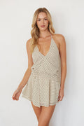 Woman wearing a polka dot dress against a white background