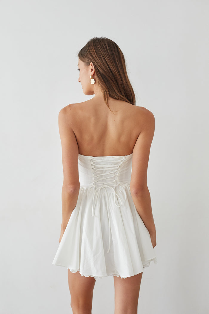 back-image | Back-image | White Strapless Dress | back view revealing the simple yet elegant design of the dress, with the bodice forming a smooth shape.