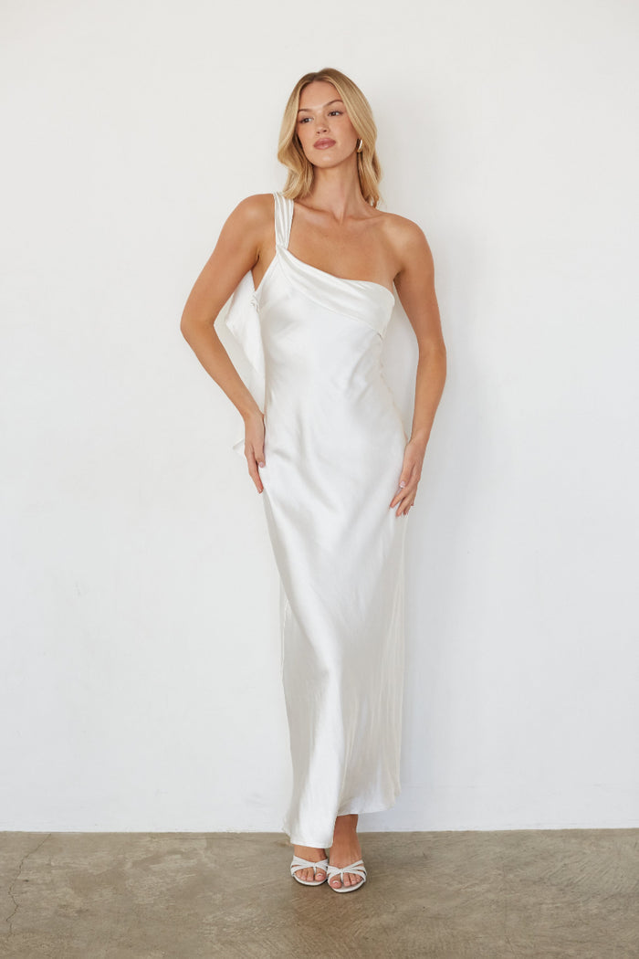 white-image | Woman wearing a white one-shoulder dress against a plain background