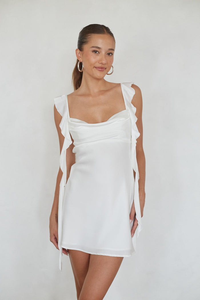 white-image | Woman wearing a white dress against a plain background