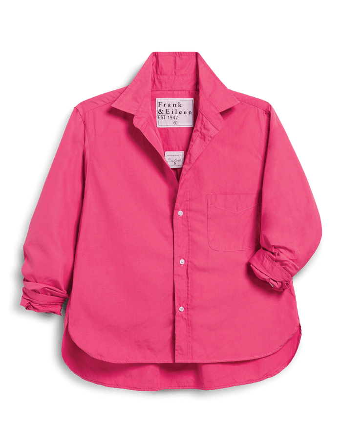 Pink shirt with rolled-up sleeves on a black background