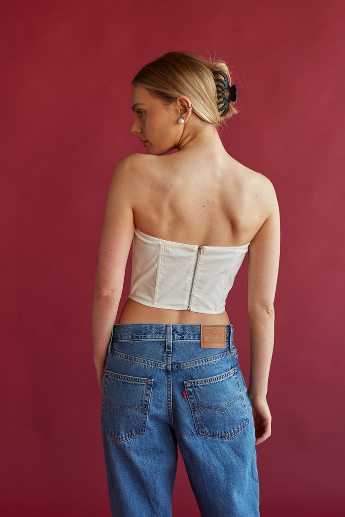white lace detailing strapless corset top with black bow detail | white crop tops for spring