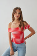 Red+White-image | front-image | off-shoulder red striped top | casual summer outfit | eye-catching striped top | playful red and white striped off-shoulder top, paired with relaxed denim jeans, perfect for a warm day out