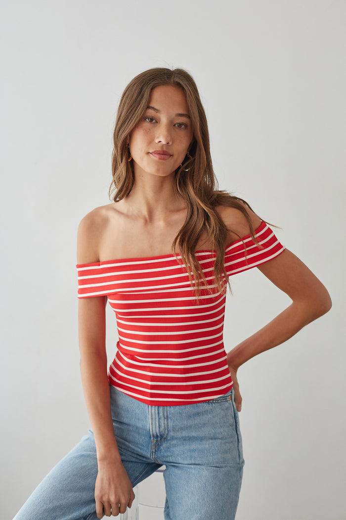 Red+White-image | front-image | off-shoulder red striped top | casual summer outfit | eye-catching striped top | playful red and white striped off-shoulder top, paired with relaxed denim jeans, perfect for a warm day out