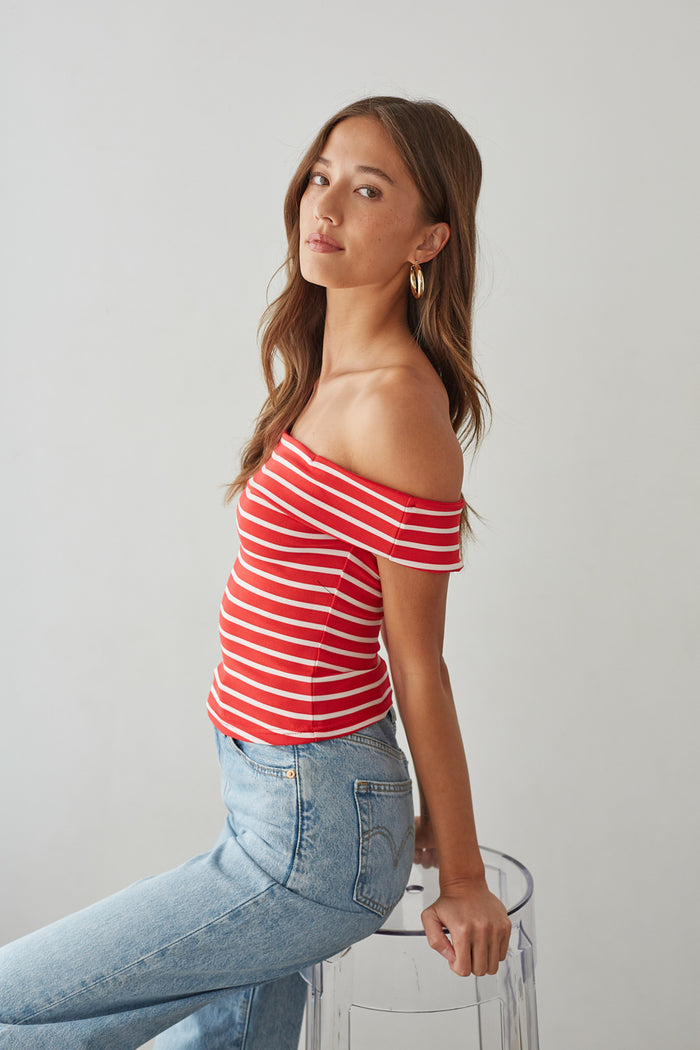 side-image | red and white striped top | off-shoulder summer look | laid-back chic outfit | stylish off-shoulder top with bold red stripes, combined with high-waisted denim jeans for a fun, casual vibe