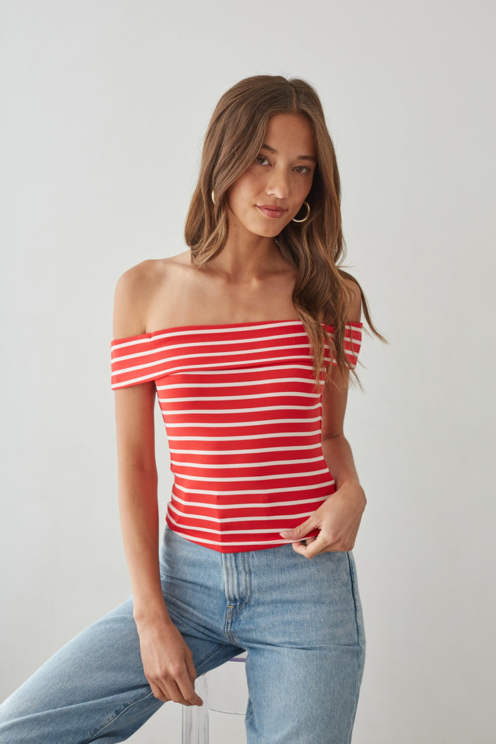 front-image | red striped off-shoulder tee | casual chic outfit | comfortable denim pairing | charming off-shoulder top with bold red stripes, styled with light denim jeans for an easygoing, fashionable look