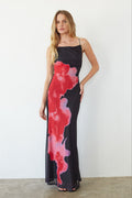 black-image | Woman wearing a black dress with red and pink abstract patterns against a white background