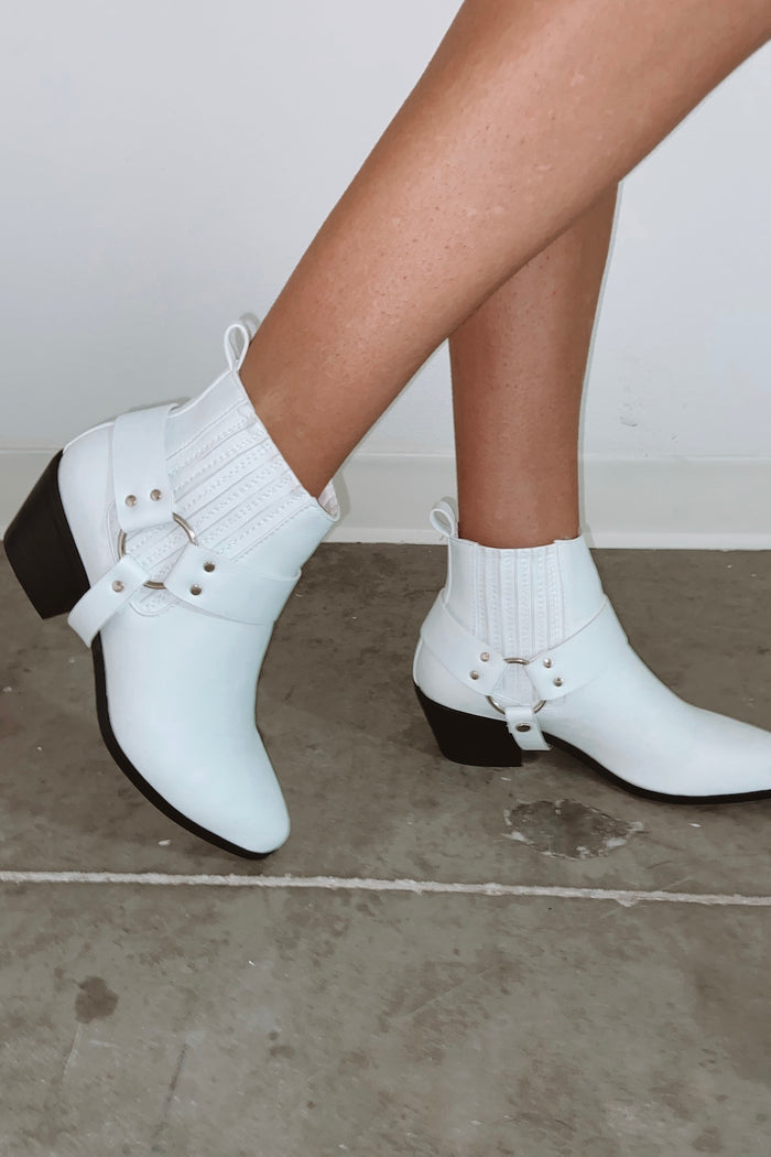 White booties with buckle detail.