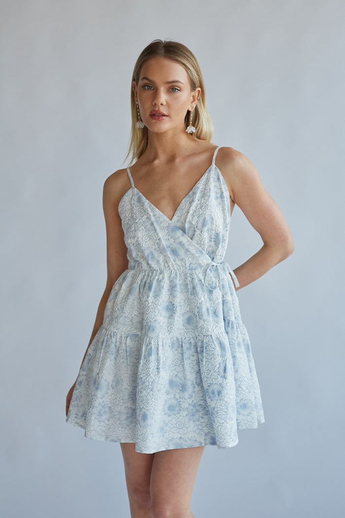 white with baby blue floral pattern and wrap fit | rush dress boutique