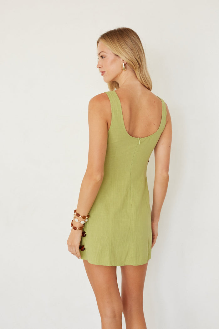 Woman wearing a green dress on a white background